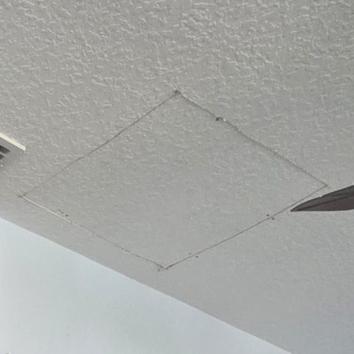 A square cutout in a textured ceiling, labeled "BEFORE," shows the area prior to repair or modification. The image captures the unfinished state of the ceiling.