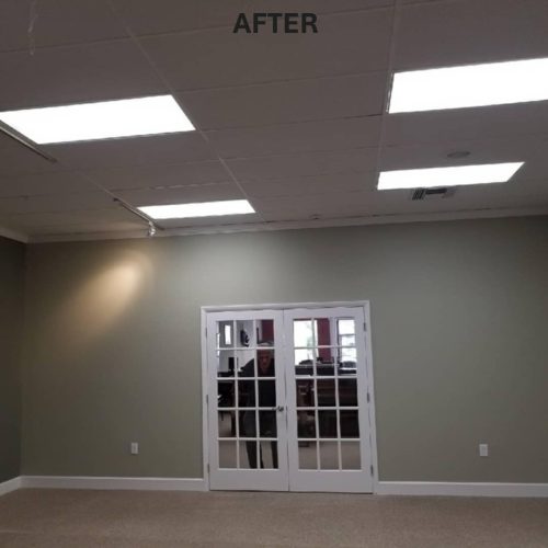 A newly renovated room with a light green wall and double glass doors, featuring bright overhead lights. The word "AFTER" is displayed above the doorway.